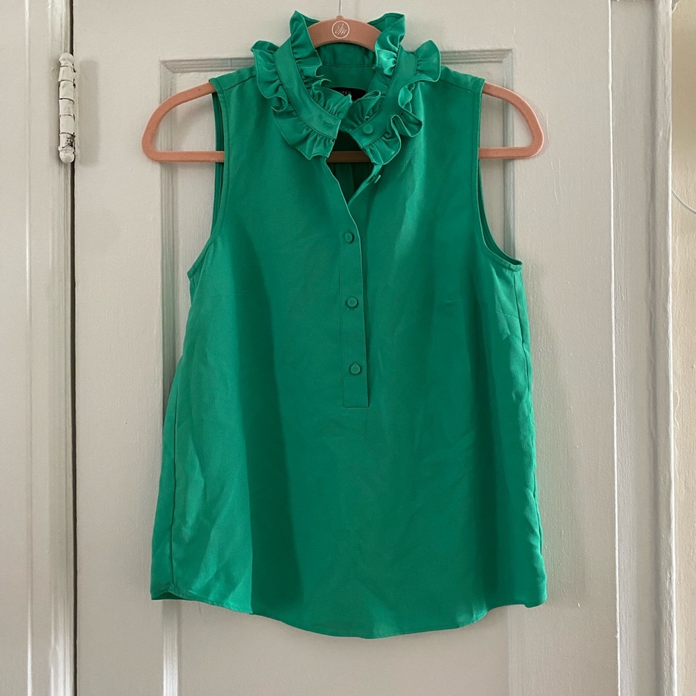 Like new (worn once). Button detailing down front and ruffle around neckline.